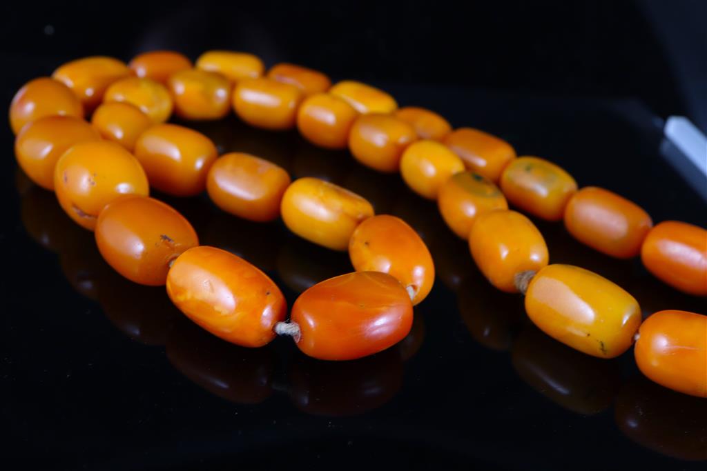 A single strand oval amber bead necklace, 74cm, gross weight 128 grams,